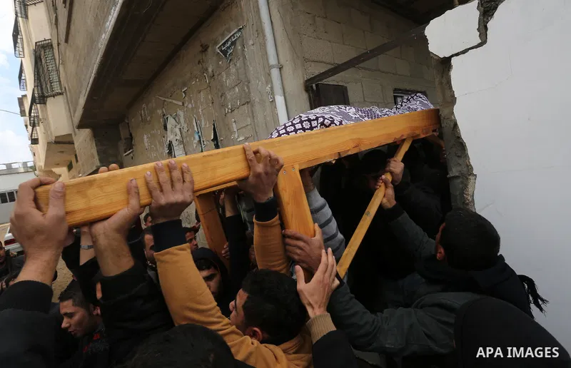 Palestinian mourners carry the body of Ishaq Hassan, 28, who was shot dead by Egyptian border guards as he crossed from the Gaza Strip into Egypt, during his funeral in Gaza city on December 31, 2015. Ishaq Hassan, who w...