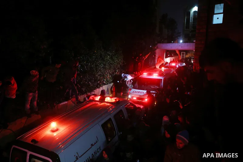 Palestinian men carry a body of a Palestinian alleged attacker upon its release by the Israeli security forces in the West Bank city of Ramallah, on December 31, 2015. Israeli authorities turned over a number of bodies t...