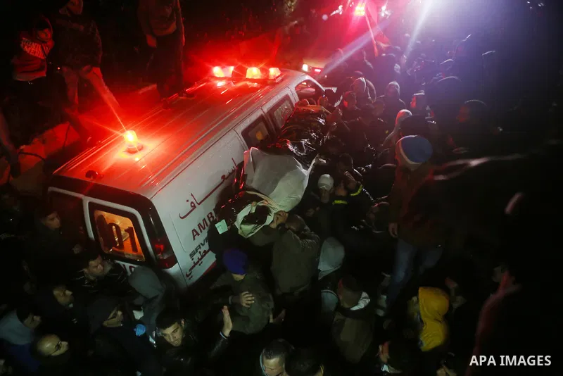 Palestinian men carry a body of a Palestinian alleged attacker upon its release by the Israeli security forces in the West Bank city of Ramallah, on December 31, 2015. Israeli authorities turned over a number of bodies t...