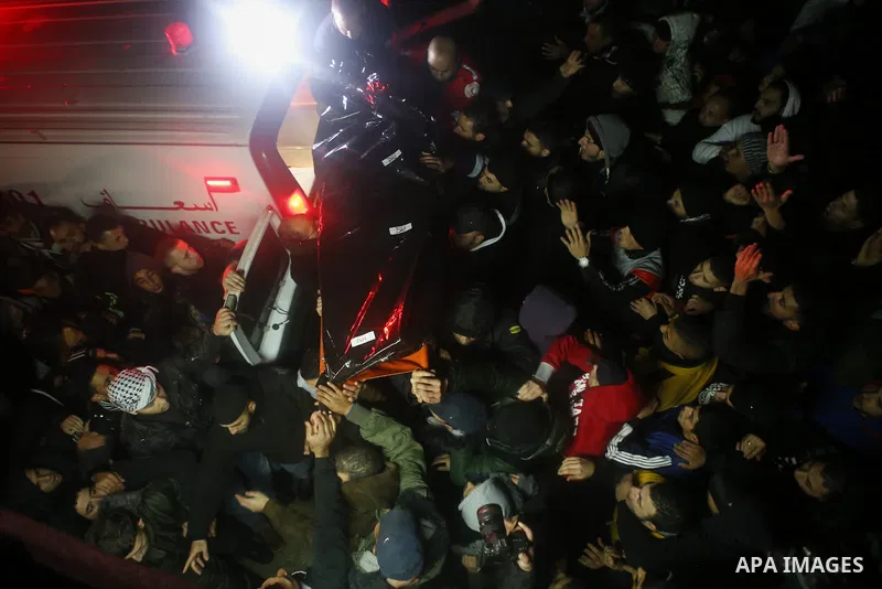 Palestinian men carry a body of a Palestinian alleged attacker upon its release by the Israeli security forces in the West Bank city of Ramallah, on December 31, 2015. Israeli authorities turned over a number of bodies t...