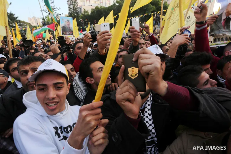 Palestinian Fatah supporters celebrate during a rally as they mark the 51st anniversary of the founding of the Fatah movement, in Gaza City December 31, 2015. Photo by Mohammed Asad