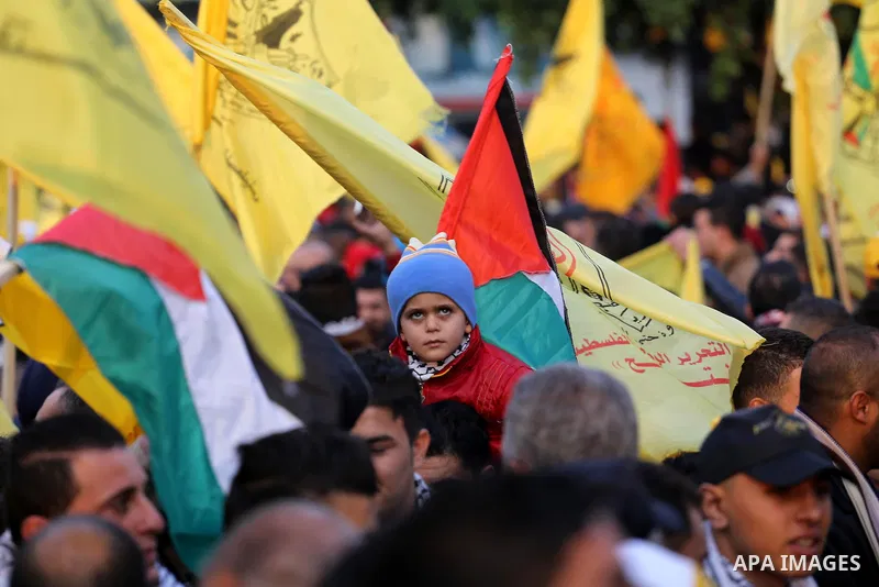 Palestinian Fatah supporters celebrate during a rally as they mark the 51st anniversary of the founding of the Fatah movement, in Gaza City December 31, 2015. Photo by Mohammed Asad