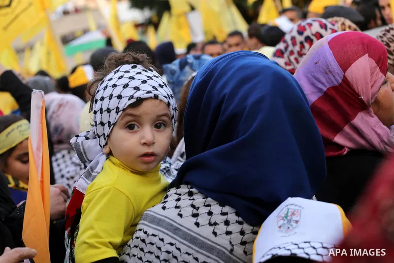Palestinian Fatah supporters celebrate during a rally as they mark the 51st anniversary of the founding of the Fatah movement, in Gaza City December 31, 2015. Photo by Mohammed Asad