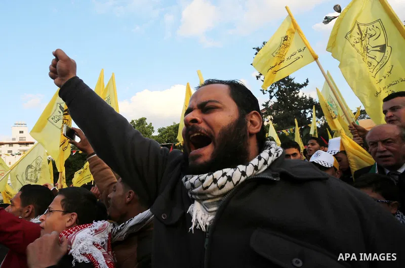 Palestinian Fatah supporters celebrate during a rally as they mark the 51st anniversary of the founding of the Fatah movement, in Gaza City December 31, 2015. Photo by Mohammed Asad