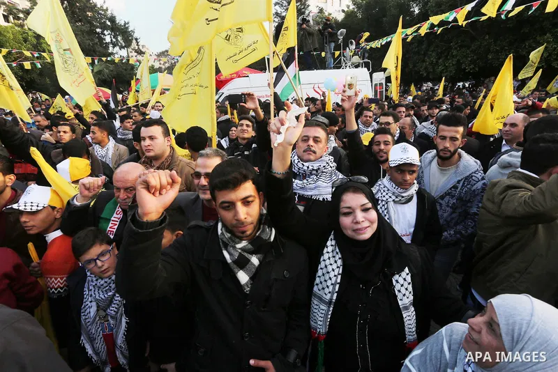 Palestinian Fatah supporters celebrate during a rally as they mark the 51st anniversary of the founding of the Fatah movement, in Gaza City December 31, 2015. Photo by Mohammed Asad