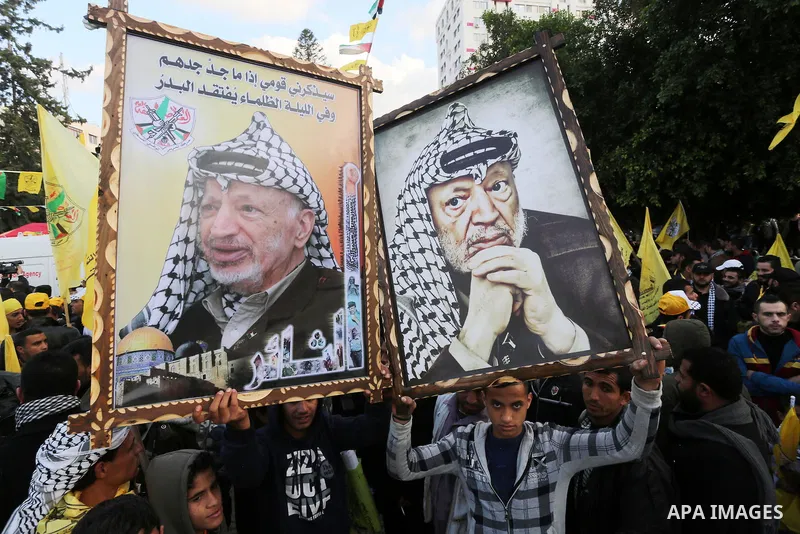 Palestinian Fatah supporters celebrate during a rally as they mark the 51st anniversary of the founding of the Fatah movement, in Gaza City December 31, 2015. Photo by Mohammed Asad