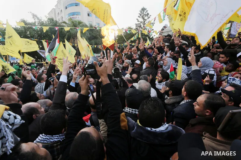 Palestinian Fatah supporters celebrate during a rally as they mark the 51st anniversary of the founding of the Fatah movement, in Gaza City December 31, 2015. Photo by Mohammed Asad