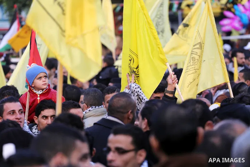 Palestinian Fatah supporters celebrate during a rally as they mark the 51st anniversary of the founding of the Fatah movement, in Gaza City December 31, 2015. Photo by Mohammed Asad