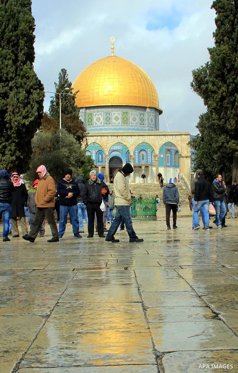 Palestinian Muslim worshipers walk in front of the Dome of the Rock mosque following Friday prayers at al-Aqsa mosque,Islam's third holiest site, in Jerusalem's Old city on Jan. 01, 2016. Photo by Mahfouz Abu Turk