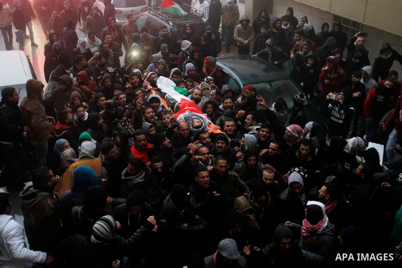 Palestinian men carry the body of a Palestinian alleged attacker upon its release by the Israeli security forces in the West Bank city of Hebron, on Jan. 01, 2016. Palestinians received on Friday 17 bodies of alleged ass...