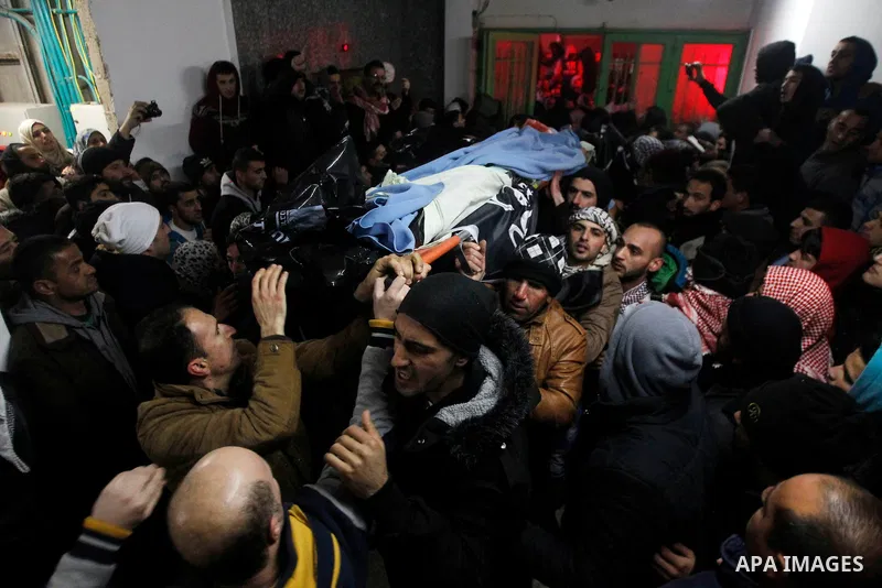 Palestinian men carry the body of a Palestinian alleged attacker upon its release by the Israeli security forces in the West Bank city of Hebron, on Jan. 01, 2016. Palestinians received on Friday 17 bodies of alleged ass...
