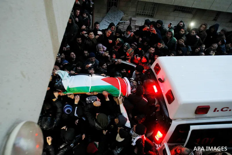 Palestinian men carry the body of a Palestinian alleged attacker upon its release by the Israeli security forces in the West Bank city of Hebron, on Jan. 01, 2016. Palestinians received on Friday 17 bodies of alleged ass...