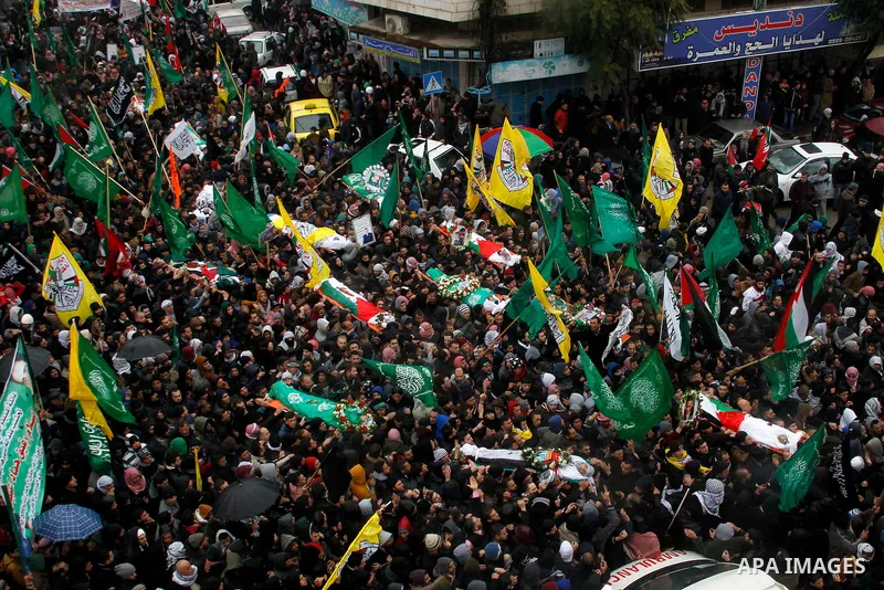 Mourners carry bodies of Palestinians, who allegedly carried out attacks against Israelis, during their funeral in the West Bank city of Hebron January 2, 2016. Palestinians received on Friday 23 bodies of alleged assail...