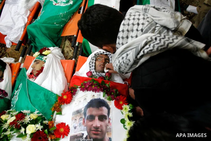 Mourners gather around the bodies of Palestinians, who allegedly carried out attacks against Israelis, during their funeral in the West Bank city of Hebron January 2, 2016. Palestinians received on Friday 23 bodies of al...