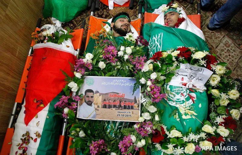 Mourners gather around the bodies of Palestinians, who allegedly carried out attacks against Israelis, during their funeral in the West Bank city of Hebron January 2, 2016. Palestinians received on Friday 23 bodies of al...