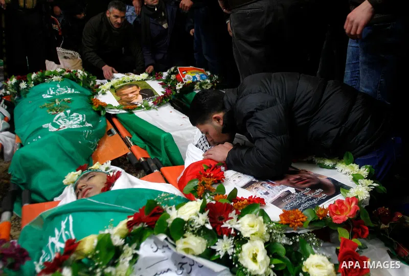Mourners gather around the bodies of Palestinians, who allegedly carried out attacks against Israelis, during their funeral in the West Bank city of Hebron January 2, 2016. Palestinians received on Friday 23 bodies of al...