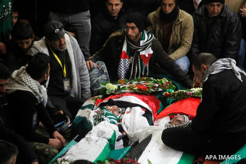 Mourners gather around the bodies of Palestinians, who allegedly carried out attacks against Israelis, during their funeral in the West Bank city of Hebron January 2, 2016. Palestinians received on Friday 23 bodies of al...