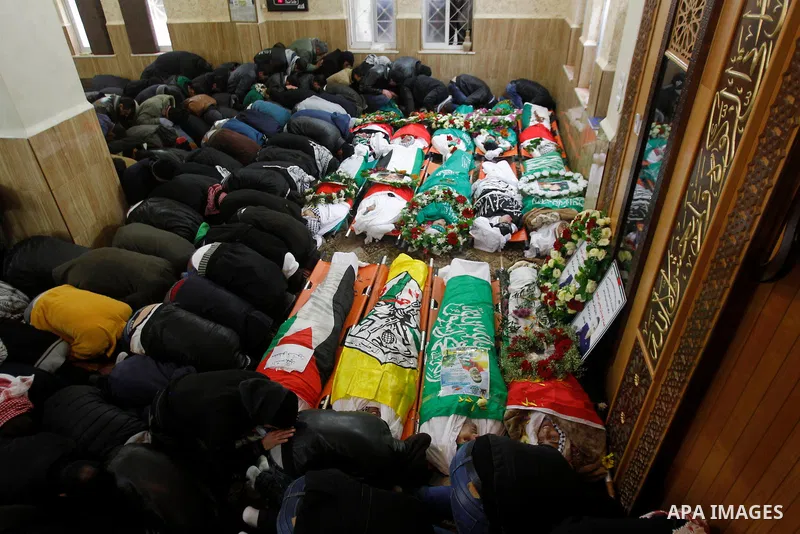 Mourners gather around the bodies of Palestinians, who allegedly carried out attacks against Israelis, during their funeral in the West Bank city of Hebron January 2, 2016. Palestinians received on Friday 23 bodies of al...