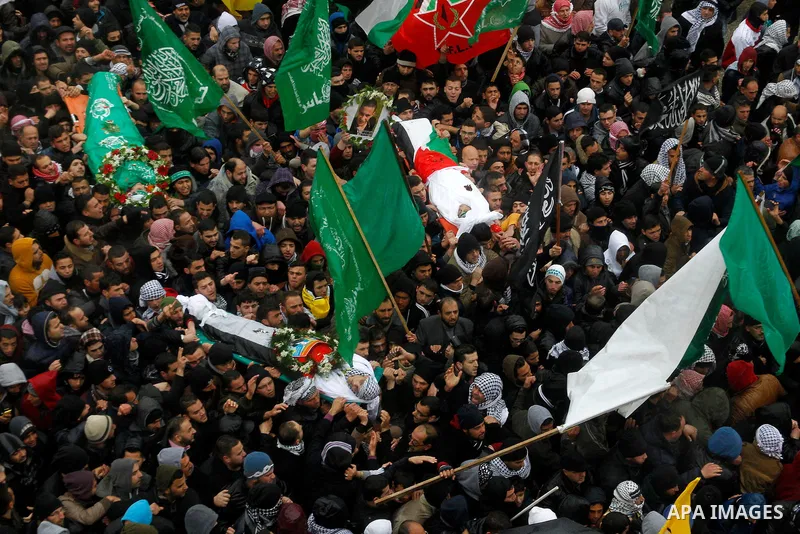 Mourners carry bodies of Palestinians, who allegedly carried out attacks against Israelis, during their funeral in the West Bank city of Hebron January 2, 2016. Palestinians received on Friday 23 bodies of alleged assail...