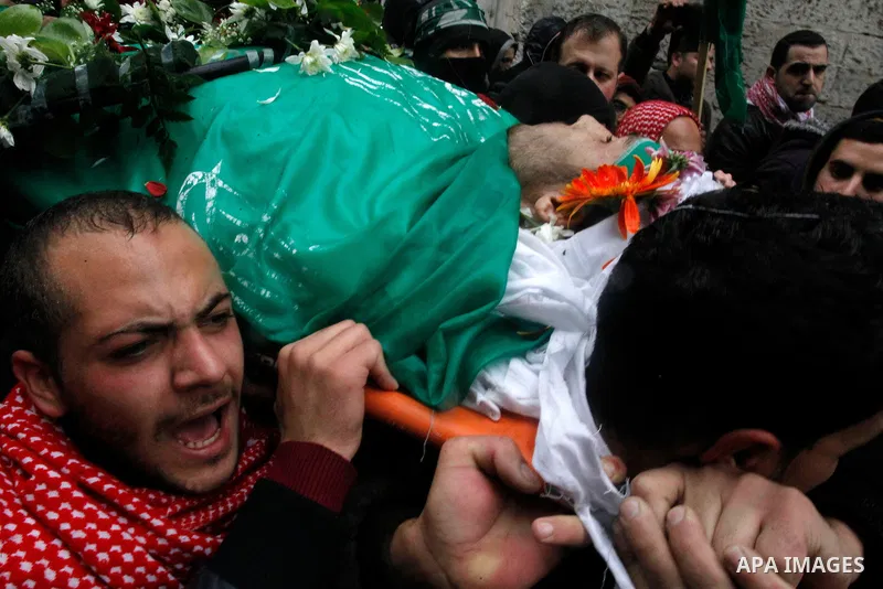 Mourners carry bodies of Palestinians, who allegedly carried out attacks against Israelis, during their funeral in the West Bank city of Hebron January 2, 2016. Palestinians received on Friday 23 bodies of alleged assail...