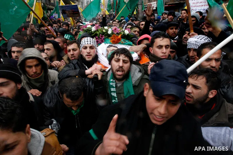 Mourners carry bodies of Palestinians, who allegedly carried out attacks against Israelis, during their funeral in the West Bank city of Hebron January 2, 2016. Palestinians received on Friday 23 bodies of alleged assail...