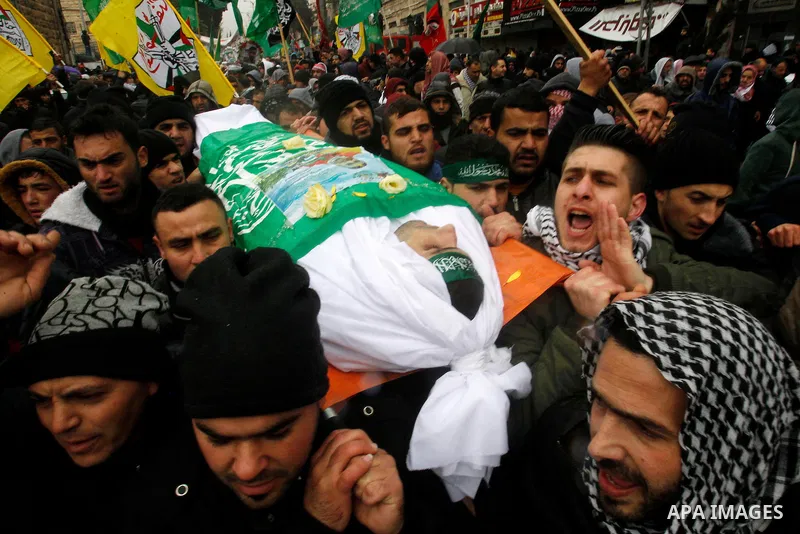 Mourners carry bodies of Palestinians, who allegedly carried out attacks against Israelis, during their funeral in the West Bank city of Hebron January 2, 2016. Palestinians received on Friday 23 bodies of alleged assail...