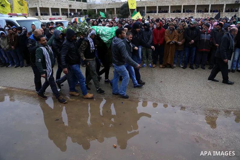 Mourners carry the bodies of Anas Hammad and Mohammed Ayyad, who allegedly carried out attacks against Israelis, during her funeral in the occupied West Bank village of Silwad, northeast of Ramallah, on January 3, 2016....