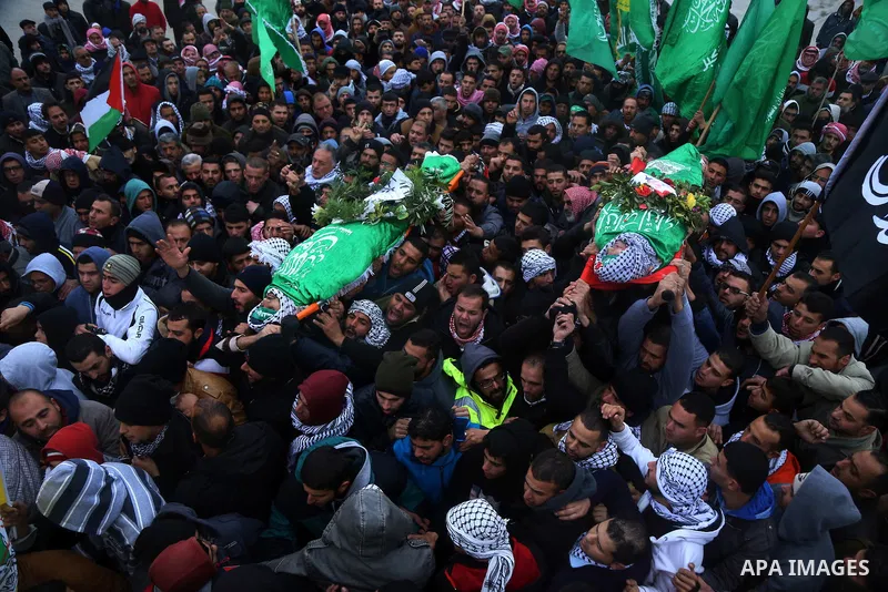 Mourners carry the bodies of Anas Hammad and Mohammed Ayyad, who allegedly carried out attacks against Israelis, during her funeral in the occupied West Bank village of Silwad, northeast of Ramallah, on January 3, 2016....