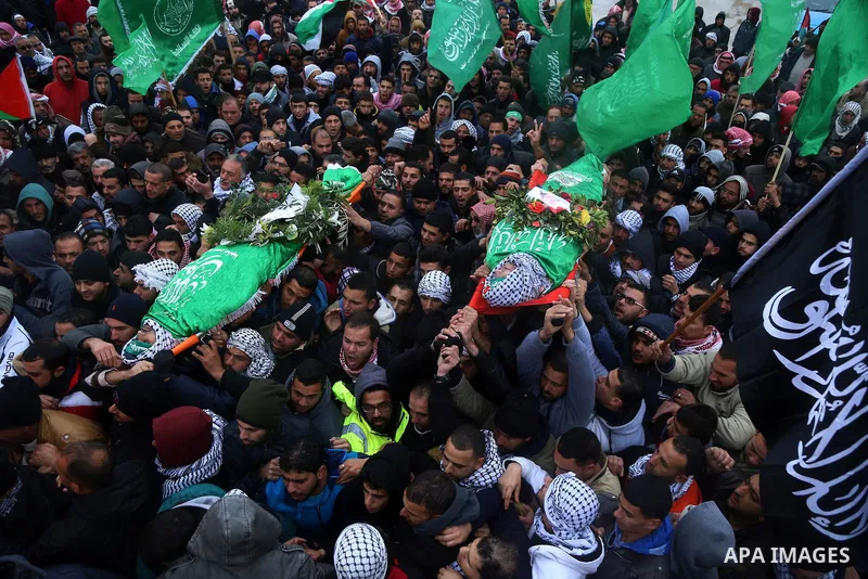Mourners carry the bodies of Anas Hammad and Mohammed Ayyad, who allegedly carried out attacks against Israelis, during her funeral in the occupied West Bank village of Silwad, northeast of Ramallah, on January 3, 2016....
