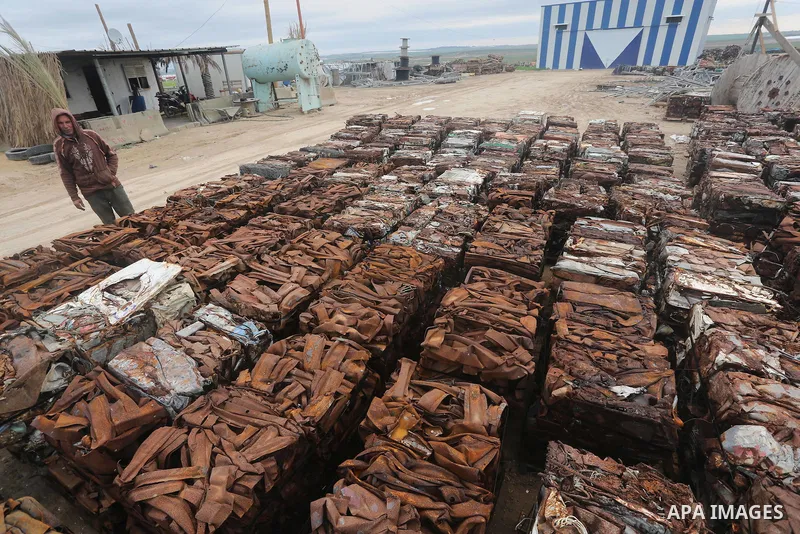 A Palestinian labourer works at workshop for scrap iron compress in Gaza city, on January 3, 2016. Photo by Mohammed Asad