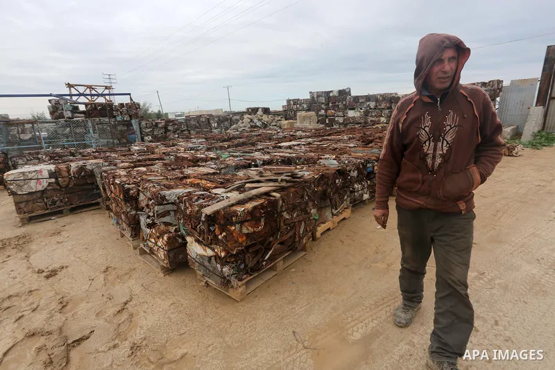 A Palestinian labourer works at workshop for scrap iron compress in Gaza city, on January 3, 2016. Photo by Mohammed Asad