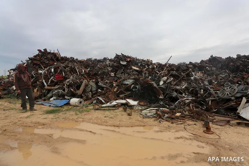 A Palestinian labourer works at workshop for scrap iron compress in Gaza city, on January 3, 2016. Photo by Mohammed Asad