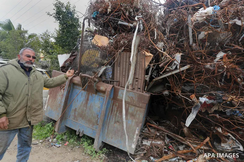 A Palestinian labourer works at workshop for scrap iron compress in Gaza city, on January 3, 2016. Photo by Mohammed Asad