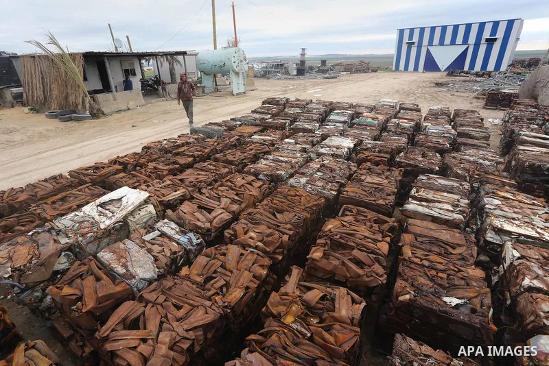 A Palestinian labourer works at workshop for scrap iron compress in Gaza city, on January 3, 2016. Photo by Mohammed Asad