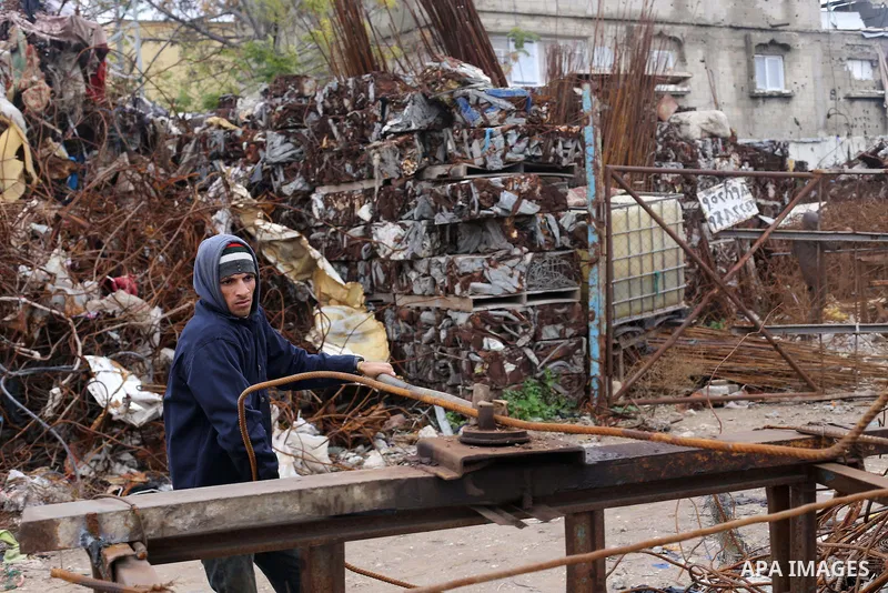 A Palestinian labourer works at workshop for scrap iron compress in Gaza city, on January 3, 2016. Photo by Mohammed Asad