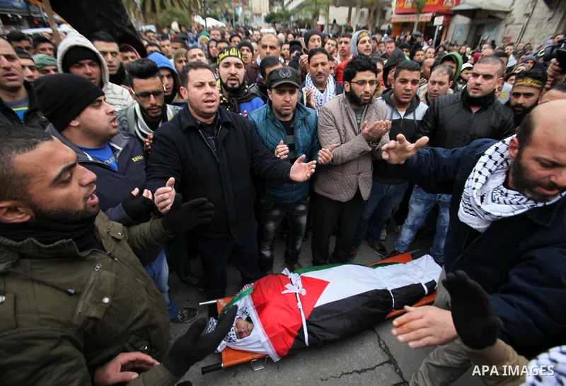 Palestinian mourners pray over the body of a 16-year-old girl Ashraqat Qatanani, who allegedly carried out an attack against Israelis, after her body was released by Israel, during her funeral in Askar refugee camp near...