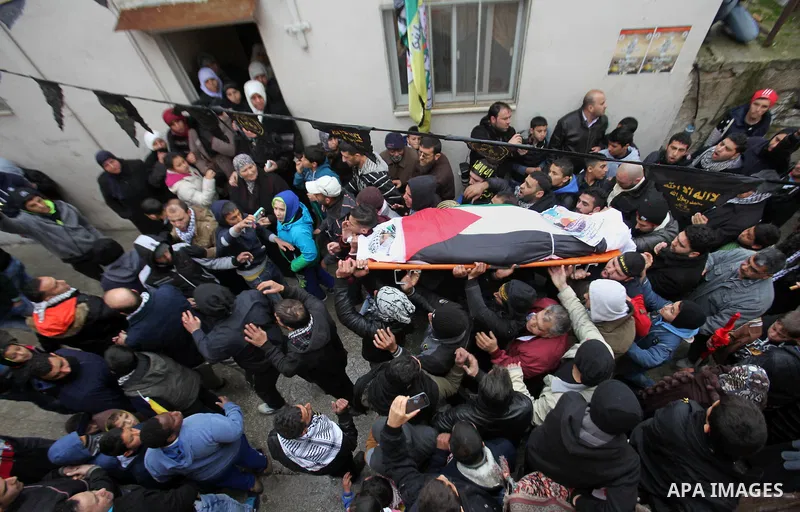 Mourners carry the body of a 16-year-old girl Ashraqat Qatanani, who allegedly carried out an attack against Israelis, after her body was released by Israel, during her funeral in Askar refugee camp near the West Bank ci...