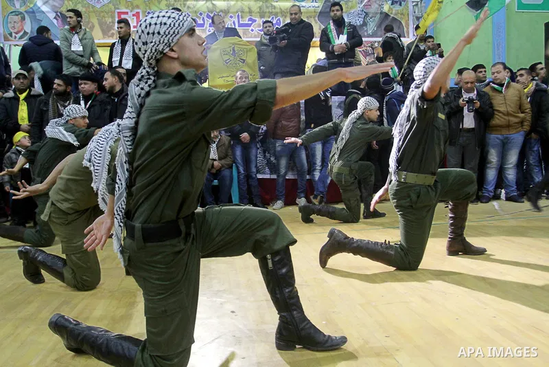Palestinian Fatah supporters celebrate during a rally as they mark the 51st anniversary of the founding of the Fatah movement, in Rafah in the southern of Gaza strip Jan. 03, 2016. Photo by Abed Rahim Khatib