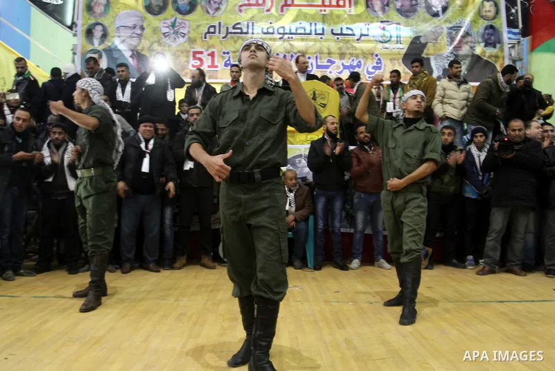 Palestinian Fatah supporters celebrate during a rally as they mark the 51st anniversary of the founding of the Fatah movement, in Rafah in the southern of Gaza strip Jan. 03, 2016. Photo by Abed Rahim Khatib