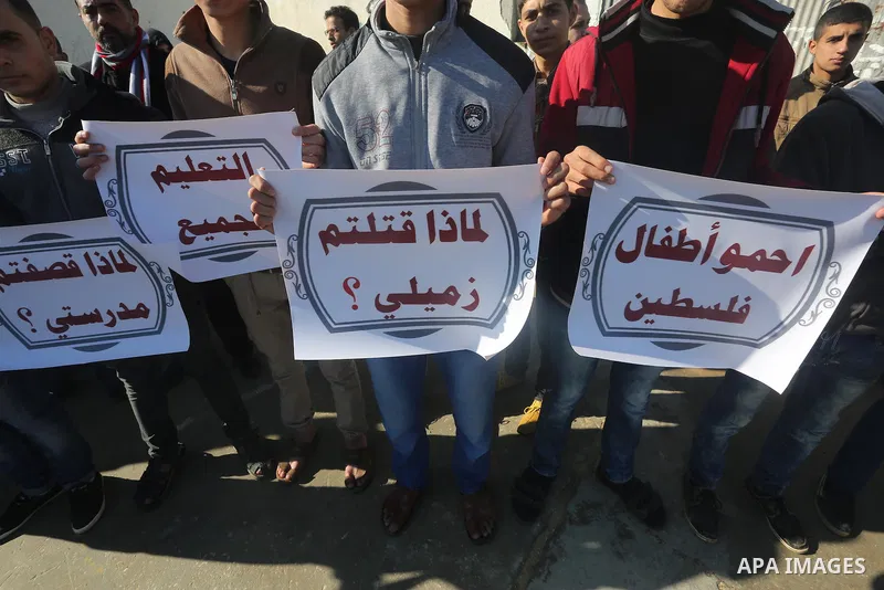 Palestinian students take part in a protest demanding reconstruction of the schools, in Gaza city, on January 4, 2016. Photo by Mohammed Asad