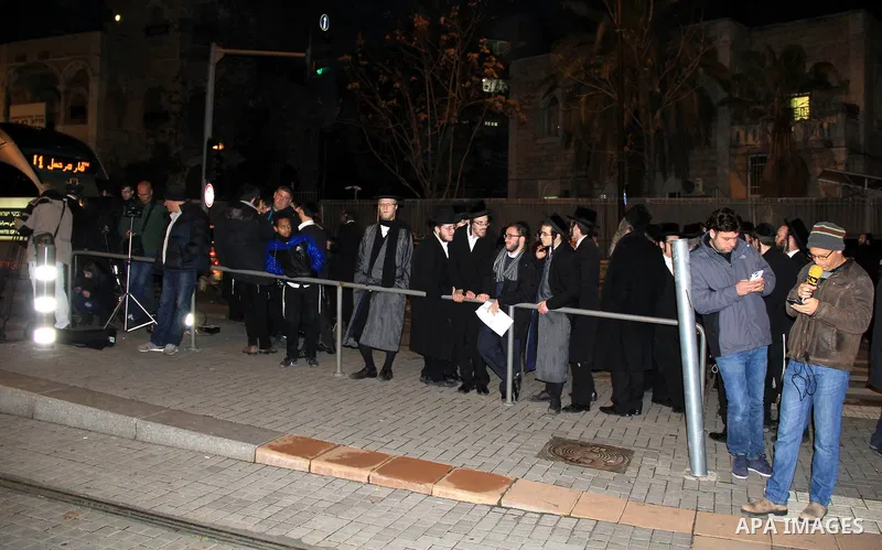 Orthodox Jews gather at the site of an attack near Jerusalem's light rail train service on January 4, 2016, after a Palestinian tried to stab security forces, police said. A 15-year-old Israeli girl was lightly wounded i...