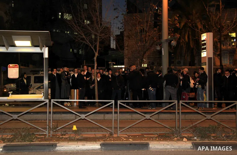 Orthodox Jews gather at the site of an attack near Jerusalem's light rail train service on January 4, 2016, after a Palestinian tried to stab security forces, police said. A 15-year-old Israeli girl was lightly wounded i...