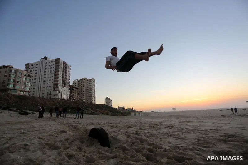 A member of Palestinian "3run Gaza" team, a street workout team practices his skills during parkour trainings at the beach of Gaza city on Jan. 05, 2016. Self-taught daredevils in the blockaded Gaza Strip are embracing a...