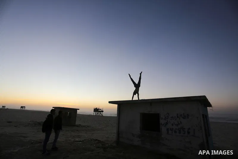 A member of Palestinian "3run Gaza" team, a street workout team practices his skills during parkour trainings at the beach of Gaza city on Jan. 05, 2016. Self-taught daredevils in the blockaded Gaza Strip are embracing a...