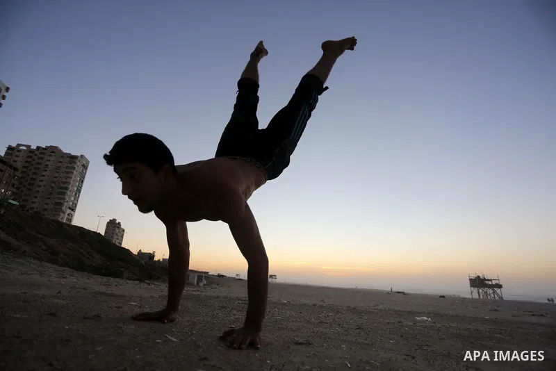 A member of Palestinian "3run Gaza" team, a street workout team practices his skills during parkour trainings at the beach of Gaza city on Jan. 05, 2016. Self-taught daredevils in the blockaded Gaza Strip are embracing a...