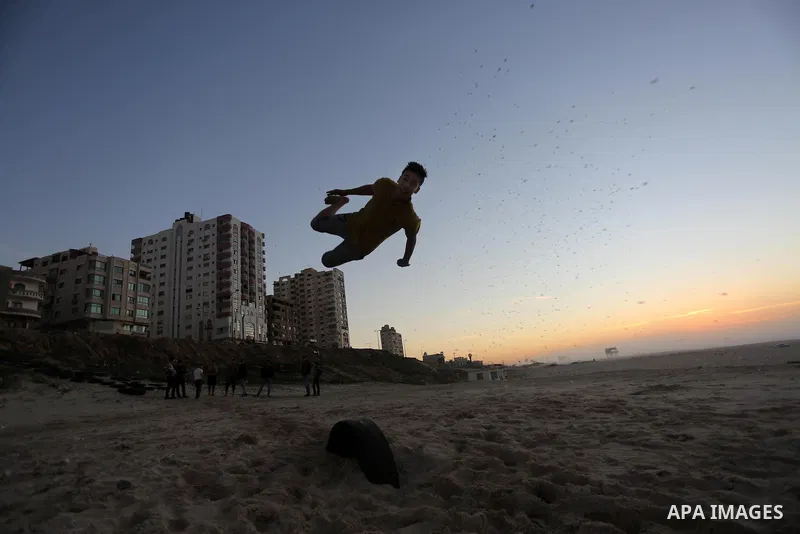 A member of Palestinian "3run Gaza" team, a street workout team practices his skills during parkour trainings at the beach of Gaza city on Jan. 05, 2016. Self-taught daredevils in the blockaded Gaza Strip are embracing a...