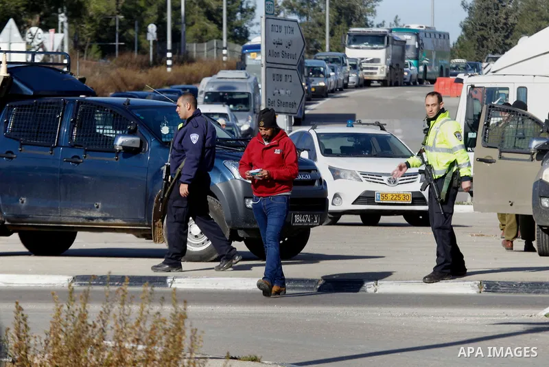 Israeli soldiers stand guard at the Gush Etzion junction in the Israeli occupied West Bank on the main road between Jerusalem and Hebron on January 5, 2016, after a Palestinian stabbed and wounded a soldier in the southe...