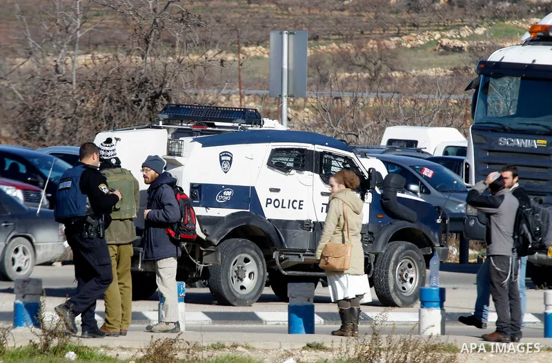 Israeli soldiers stand guard at the Gush Etzion junction in the Israeli occupied West Bank on the main road between Jerusalem and Hebron on January 5, 2016, after a Palestinian stabbed and wounded a soldier in the southe...