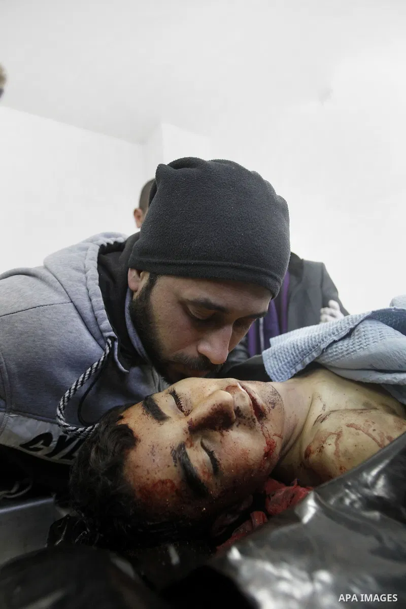 A Relative man of 18-year-old Palestinian Ahmad Younis Kawazba kisses his head at a hospital in the West Bank city of Hebron on Jan. 05, 2016. Kawazba was shot dead after he reportedly stabbed an Israeli soldier at the G...