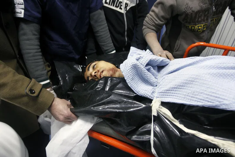 Palestinians mourners gather around the body of 18-year-old Ahmad Younis Kawazba at a hospital in the West Bank city of Hebron on Jan. 05, 2016. Kawazba was shot dead after he reportedly stabbed an Israeli soldier at the...